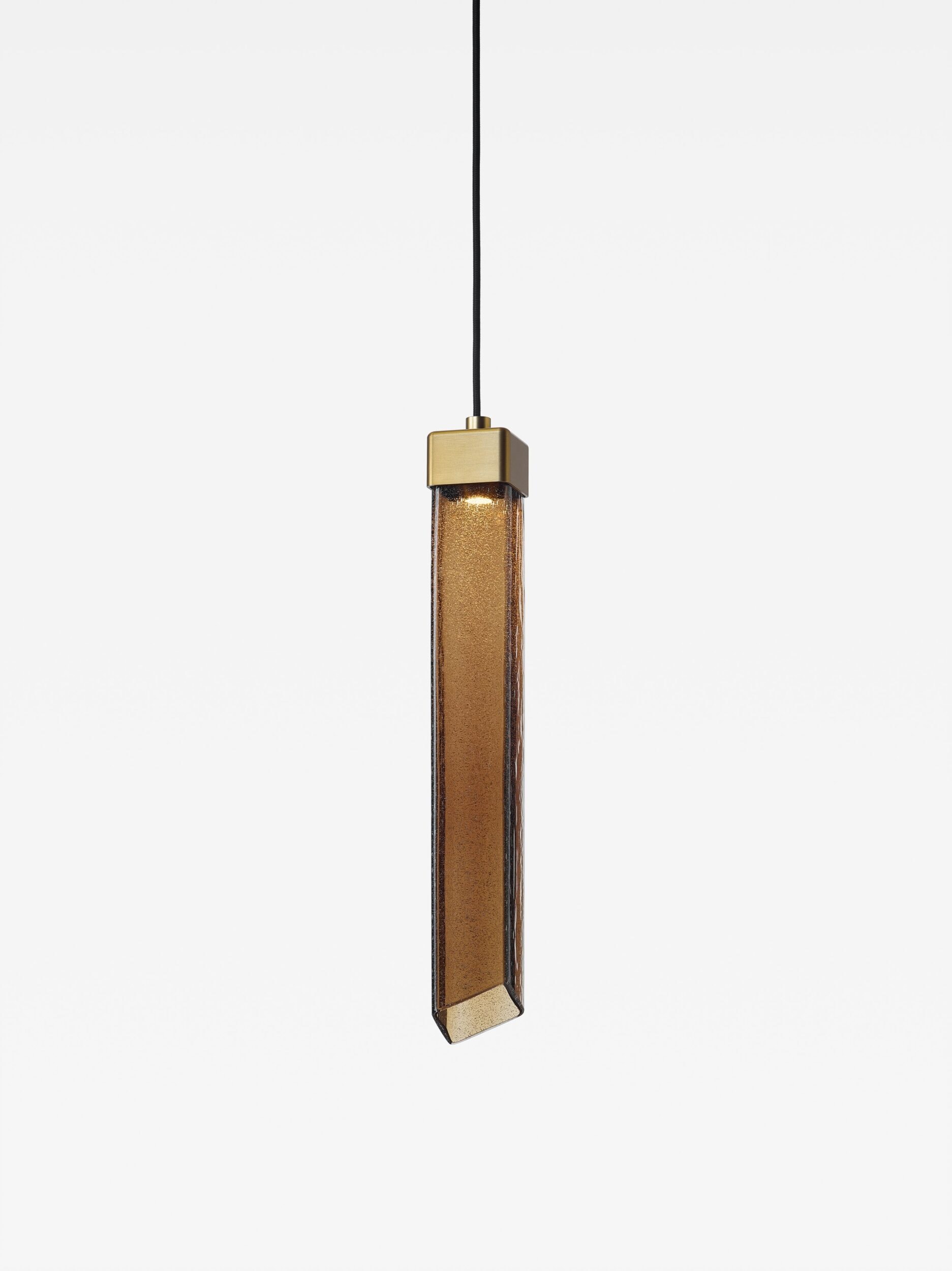 Brokis Comet Square 480 Pendant glows softly, its sculptural brown glass and brass cap exuding modern luxury.