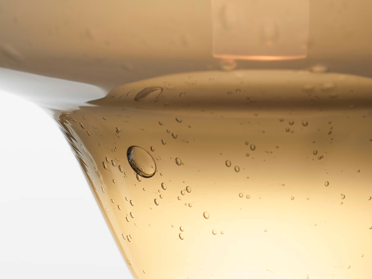 Close-up of Brokis Starcloud Vega opaline tinted glass form with delicate air bubbles.