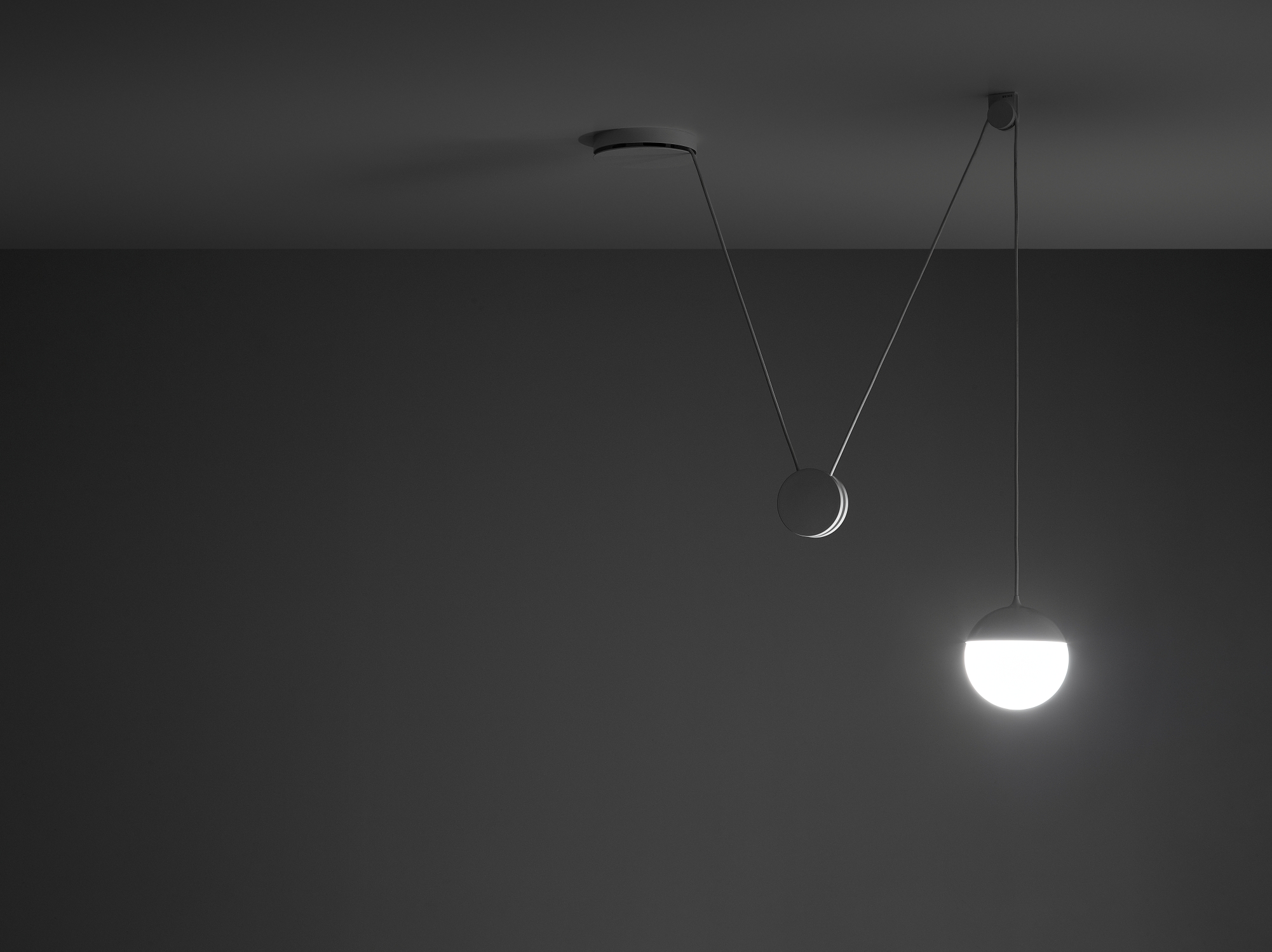 Brokis Planets 1 Set in a minimalist room with dark walls showcases its handblown orb casting a soft glow below.