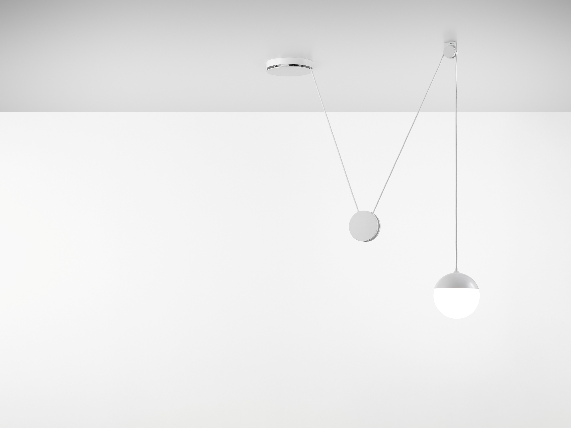 Brokis Planets 1 Set on a minimal white ceiling with geometric suspended elements.
