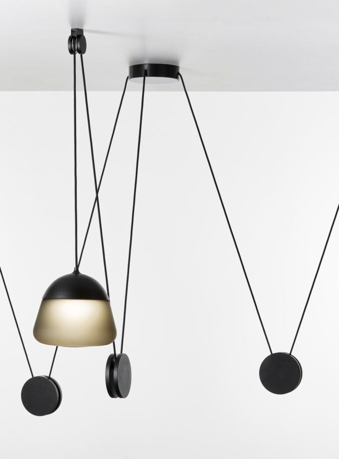 Brokis Planets 3 Set showcases sculptural, handblown pendants with grey glass and black accents, suspended in style.