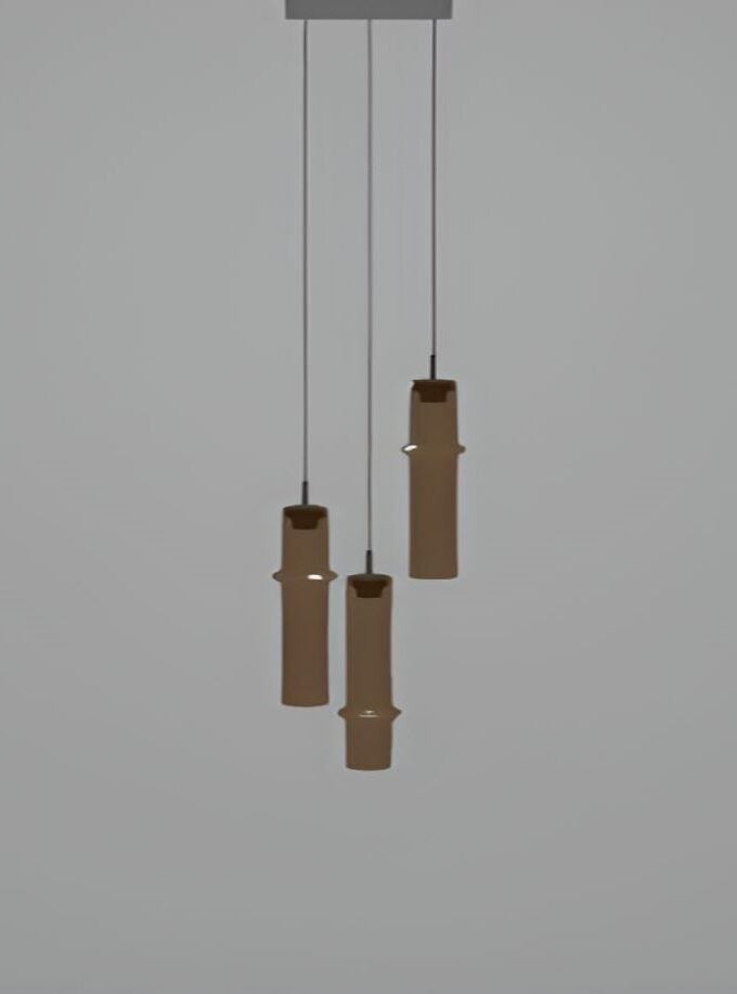 Sculptural Brokis Bamboo Forest C3B pendant lights in natural bamboo hang artfully at varying heights against a pale grey backdrop.