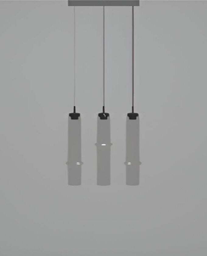 Three Brokis Bamboo Forest R3B pendants hang in a row, each casting a sculptural, narrow beam against a light grey backdrop.