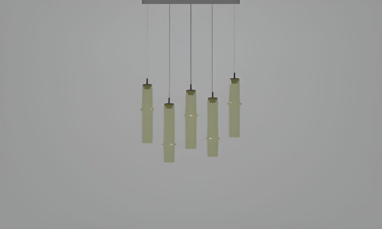 Brokis Bamboo Forest R5D pendants in soft green-yellow glass, hand-blown and sculptural, glow luxuriously in staggered heights.