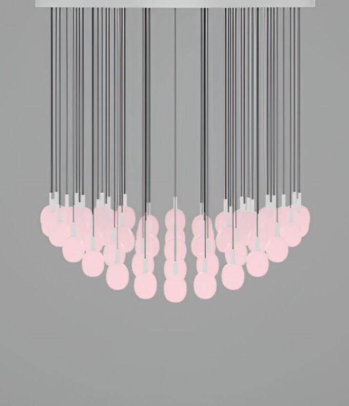 The Brokis Ivy Single C64A chandelier, with handblown pink bulbs, casts a sculptural glow from black cords against grey.