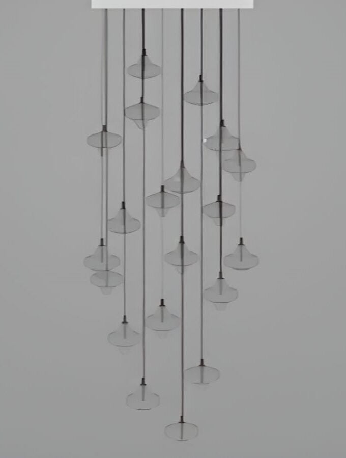Brokis Starcloud S20A chandelier: handblown crystal shades on sculptural black cords, cascading elegantly against a grey backdrop.