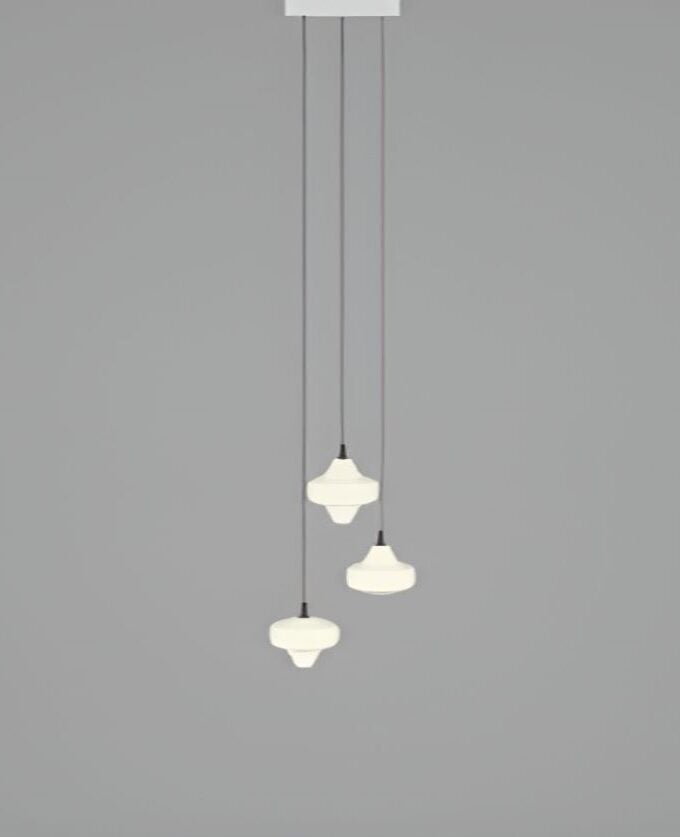 Brokis Starcloud C3A pendants with sculptural, handblown white shades hang at varied heights, exuding modern luxury.