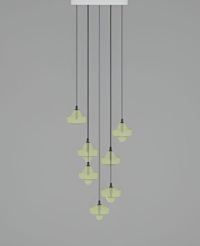 Nine Brokis Starcloud C7A pendant lights with faceted, frosted yellow-green glass shades cluster luxuriously on black flexes.
