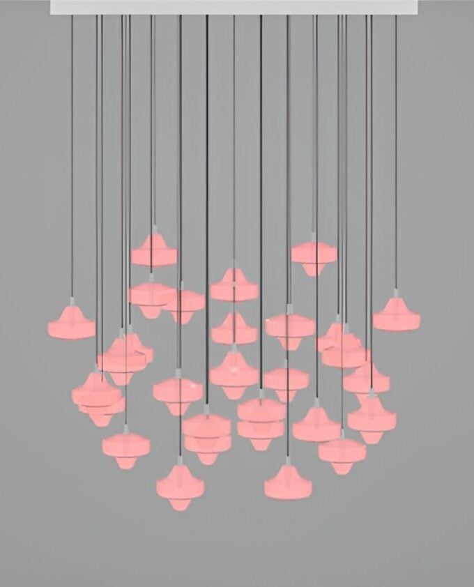 A sculptural Starcloud S29A chandelier with pink hand-blown glass shades on black flexes, set against a sleek grey backdrop.