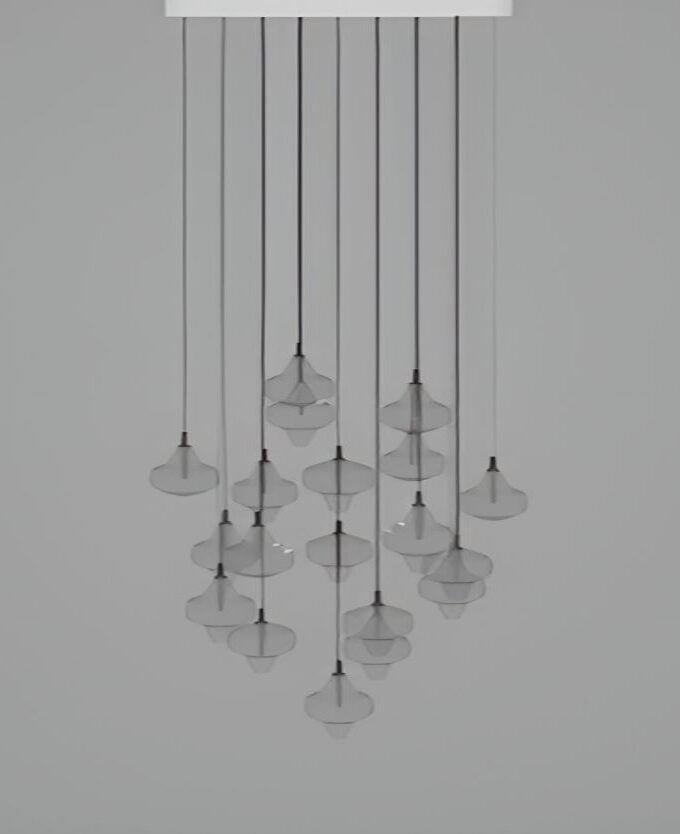 The Starcloud C19A by Brokis displays handblown, sculptural pendants in a luminous cluster, suspended on sleek black flexes.