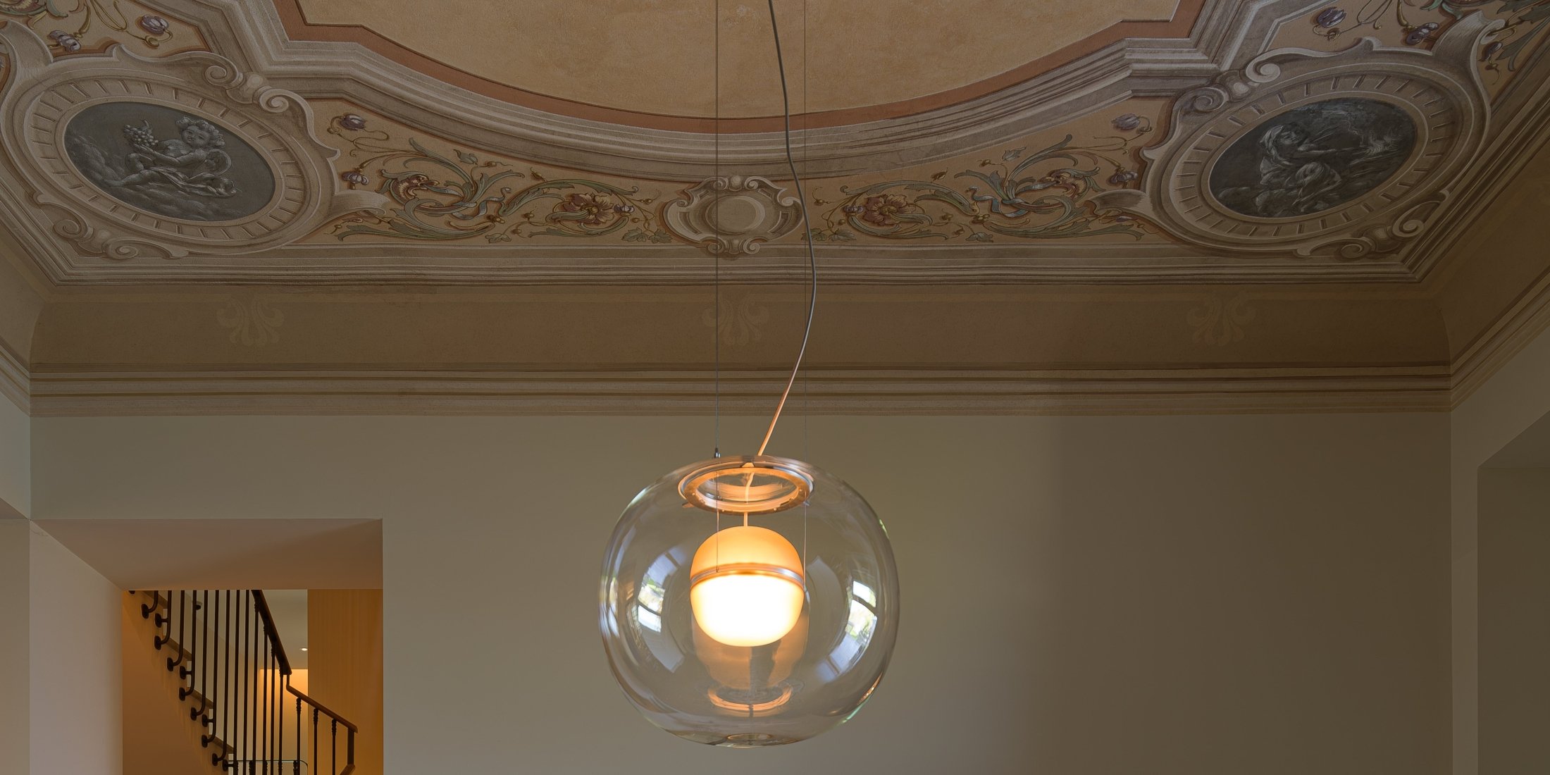 Brokis Big One Large Pendant glows beneath an ornate classical ceiling with frescoes and elegant moulding.