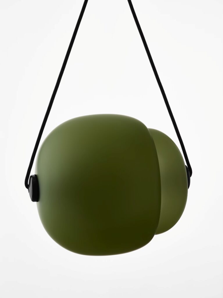 Brokis Capsula Single Pendants in handblown olive green glass hangs from a black strap, exuding modern minimalist luxury.
