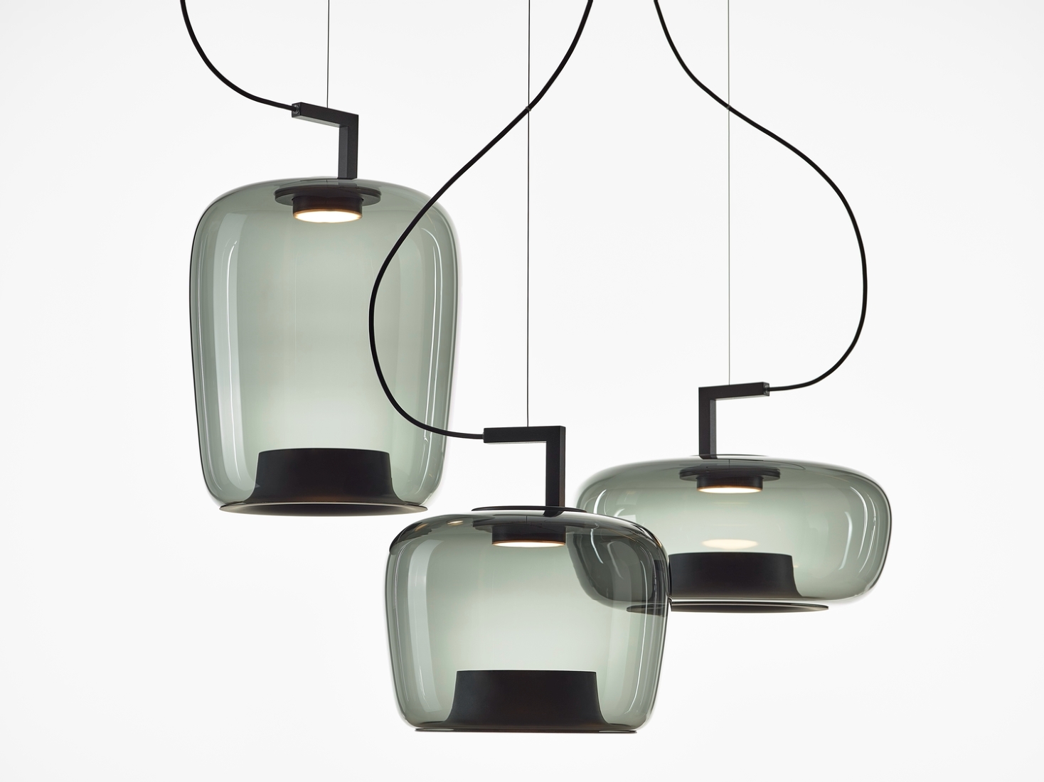 Brokis Double pendants in handblown smoke grey glass hang at varied heights for a luxe, minimalist effect.