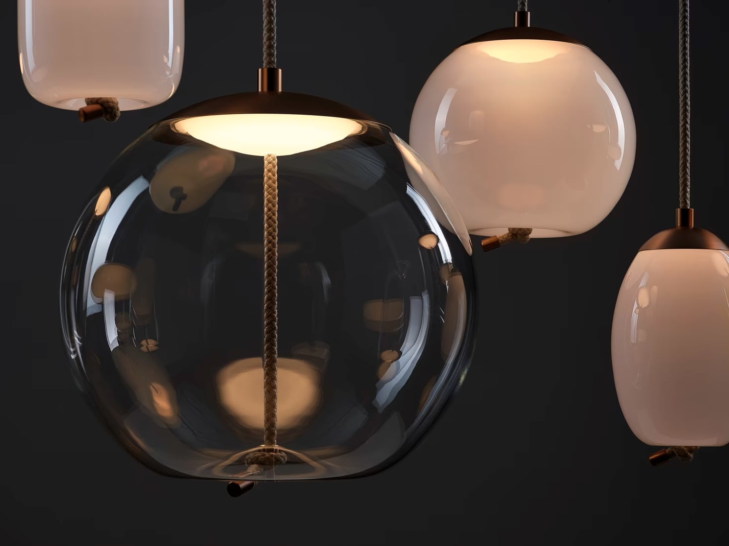Brokis Knot pendants with sculptural, rounded glass shades cast a warm glow and elegant reflections in the dark.