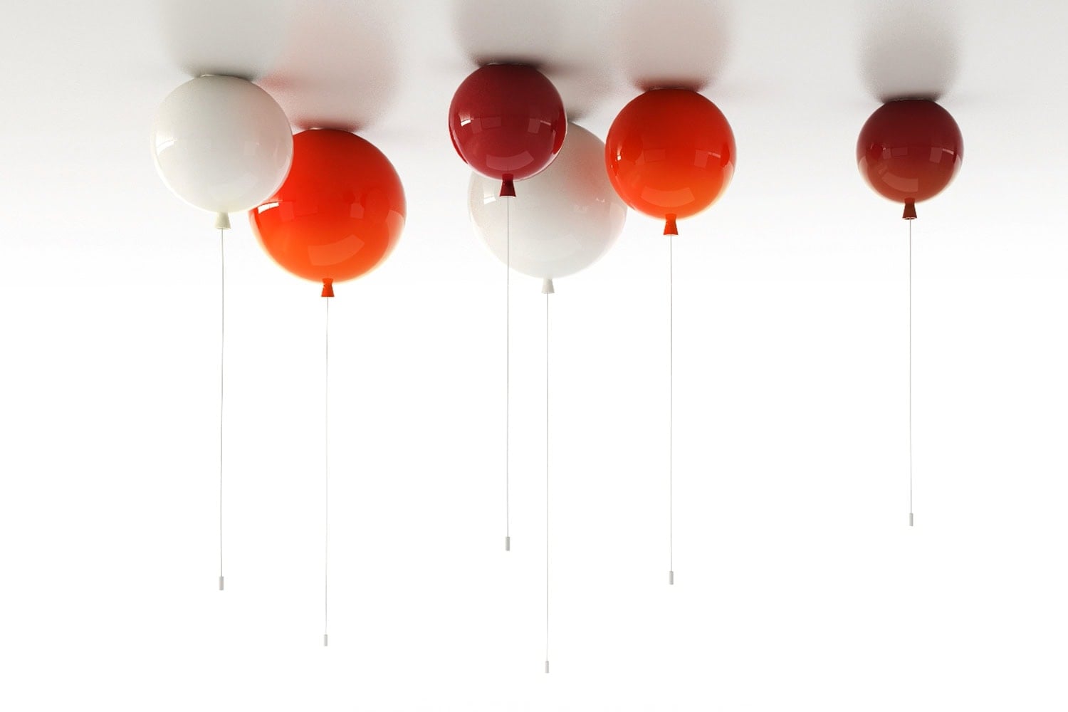Six Brokis Memory balloon lights in red, orange, and white ceiling mounted, their strings trailing against a white ceiling.