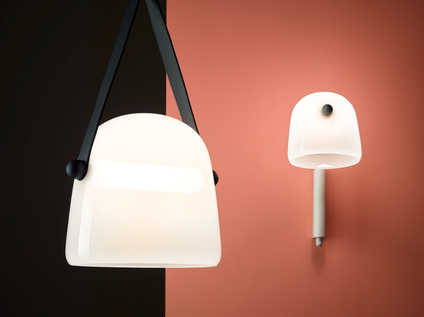 Brokis Mona lamps in smooth triplex opal glass glow against a chic black and coral wall, exuding refined minimalism.