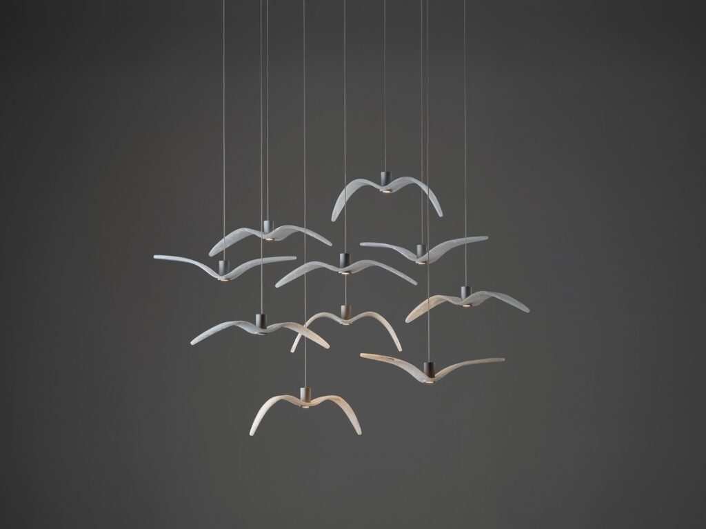 Brokis Night Birds MINI pendants with BROKISGLASS wings soar in a flock formation against a dark grey backdrop.