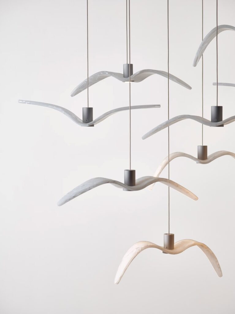 Brokis Night Birds MINI pendant lights, evoking birds in flight, in white and beige against a crisp white backdrop.