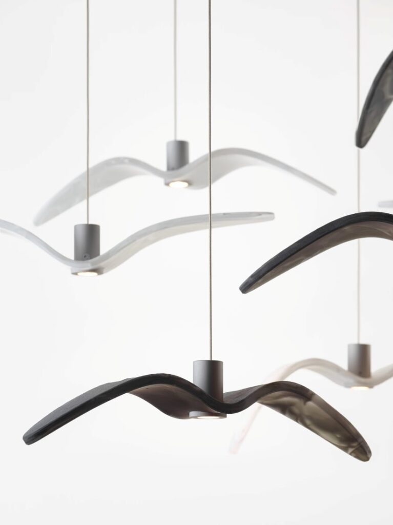 Brokis Night Birds MINI pendants evoke abstract bird wings, suspended at varied heights in sleek monochrome elegance.