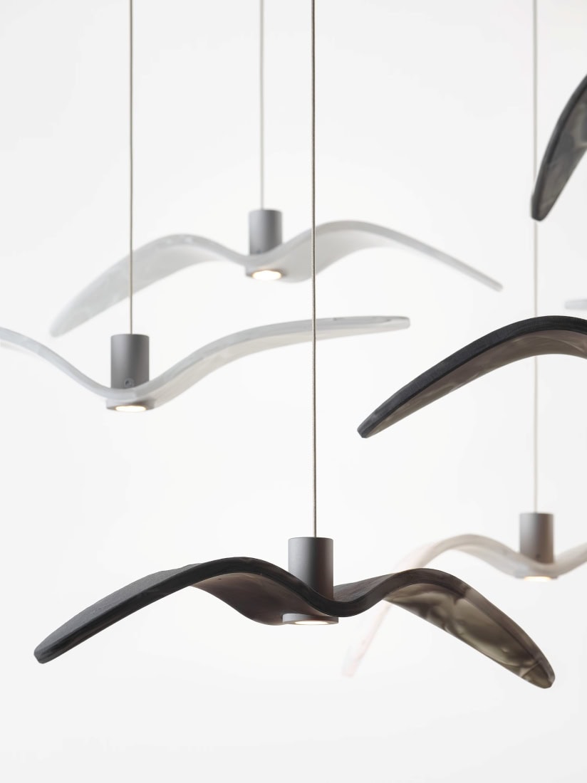 Brokis Night Birds MINI pendants evoke abstract bird wings, suspended at varied heights in sleek monochrome elegance.
