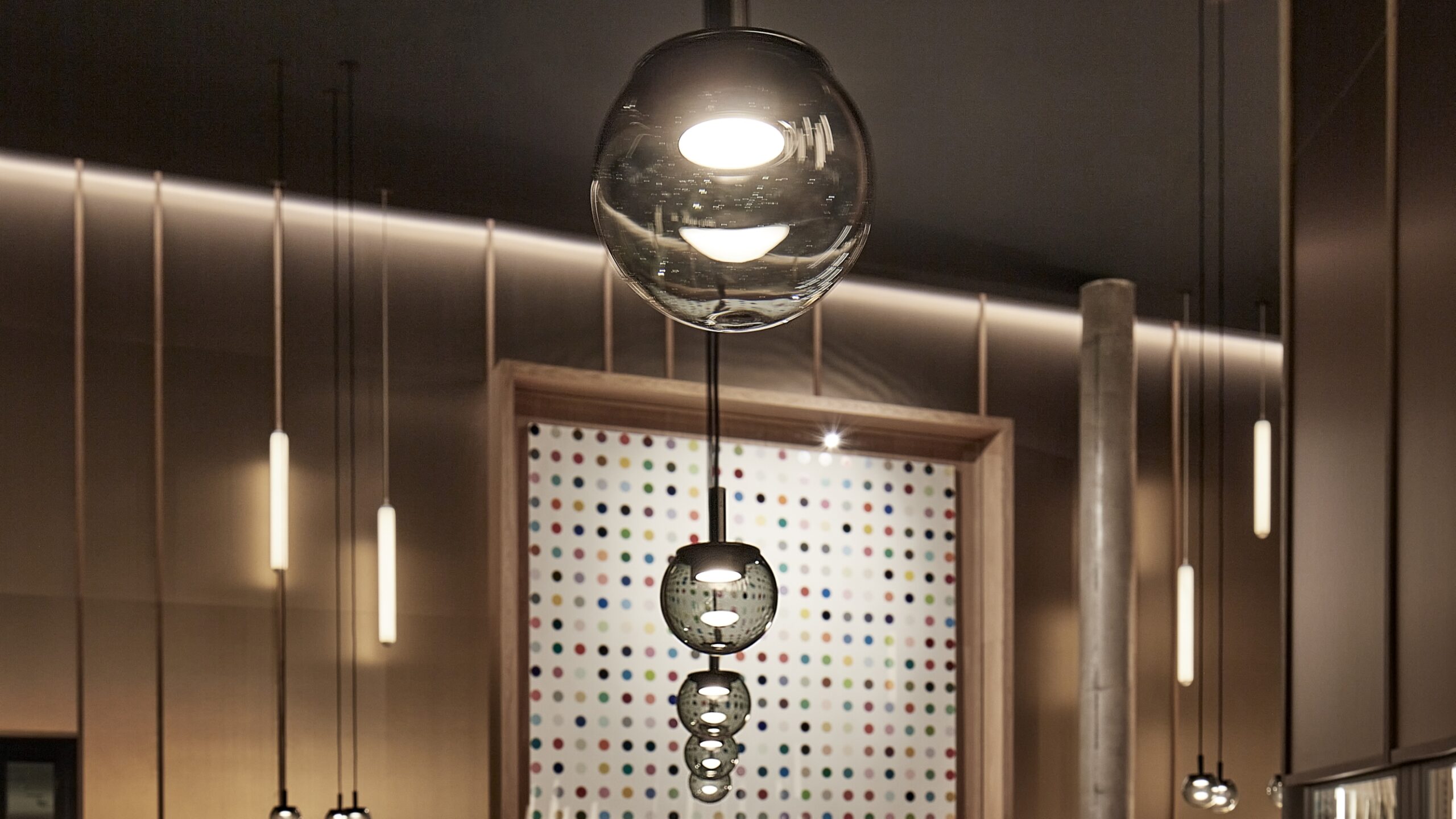 Brokis Orbis pendants with glass spheres, sculptural and luminous, float elegantly in a luxurious ceiling installation.