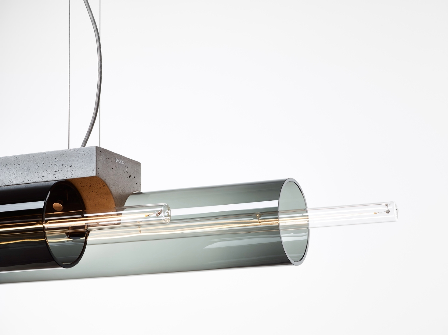 Brokis Overlay Chandlier L with handblown smoke grey glass, elegantly suspended from a sleek concrete block.