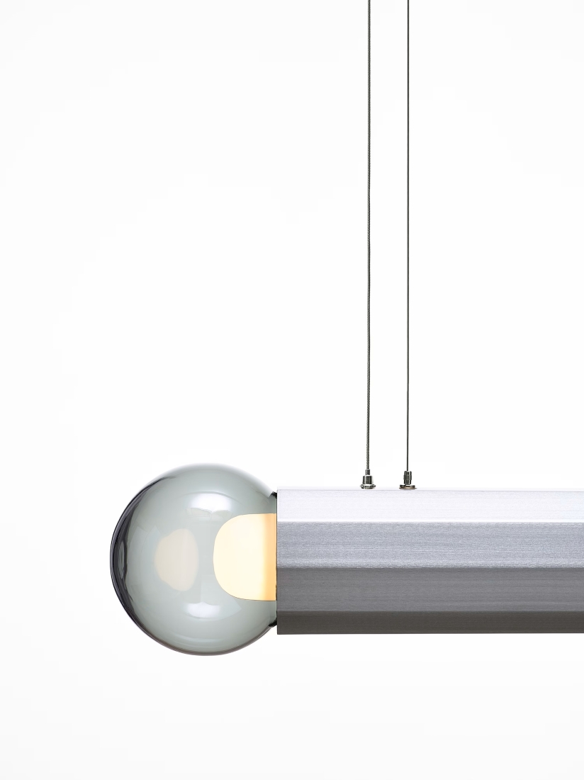 Brokis Prisma Double Small 700 with a handblown glass bulb and sleek steel body hangs elegantly from two slim cables.