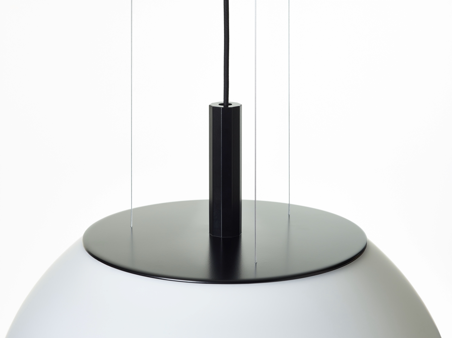 Elegant close-up of Brokis Sfera 600, with a white hand-blown dome shade and matte black detailing.