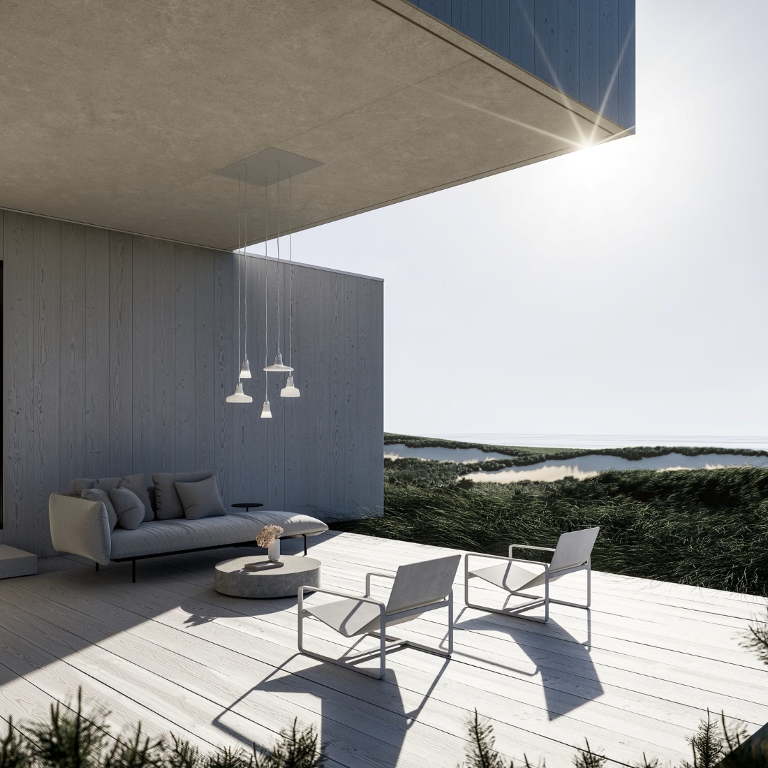 A modern patio with light wood floors, a grey sofa, white chairs, round table, and Brokis Shadows Exterior pendants.