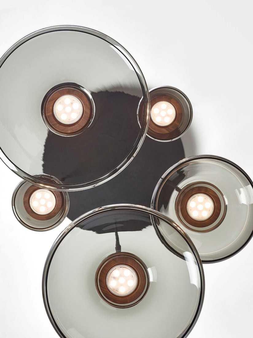 Overhead view of Brokis Shadows Set Round Canopy with five handblown crystal globes glowing in a luxe geometric display.