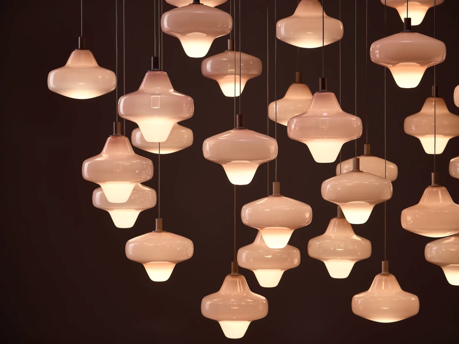 Brokis Starcloud pendants with glass shades glow warmly at varied heights, infusing the space with refined elegance.