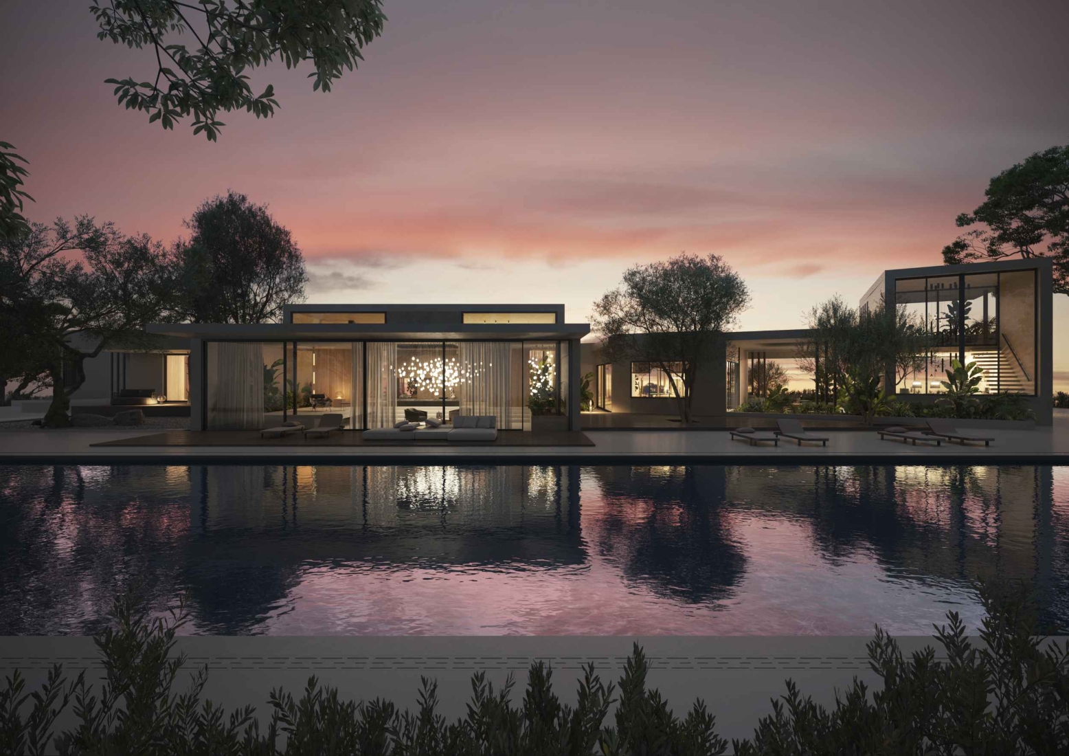 A modern luxury home with floor-to-ceiling windows glows at sunset, mirrored in a serene pool amid lush trees.