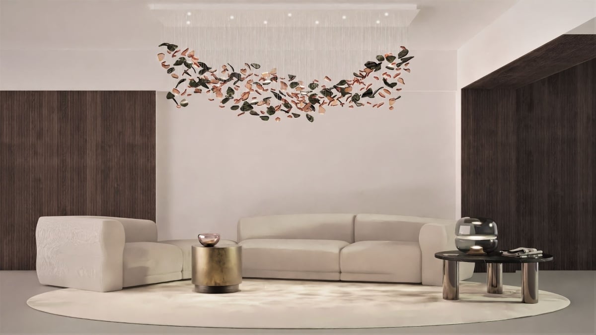 A modern living room with cream sofas, gold side table, and black coffee table beneath a BROKISGLASS Bloom Rectangular Cloud.