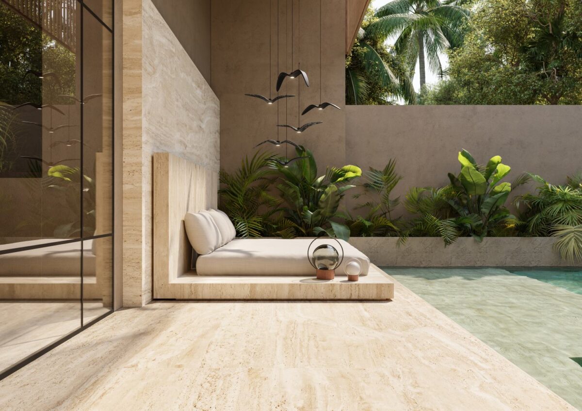 A modern lounge with a daybed, Brokis Sfera Portable glass lamp, and Night Birds overlooks a turquoise swimming pool.