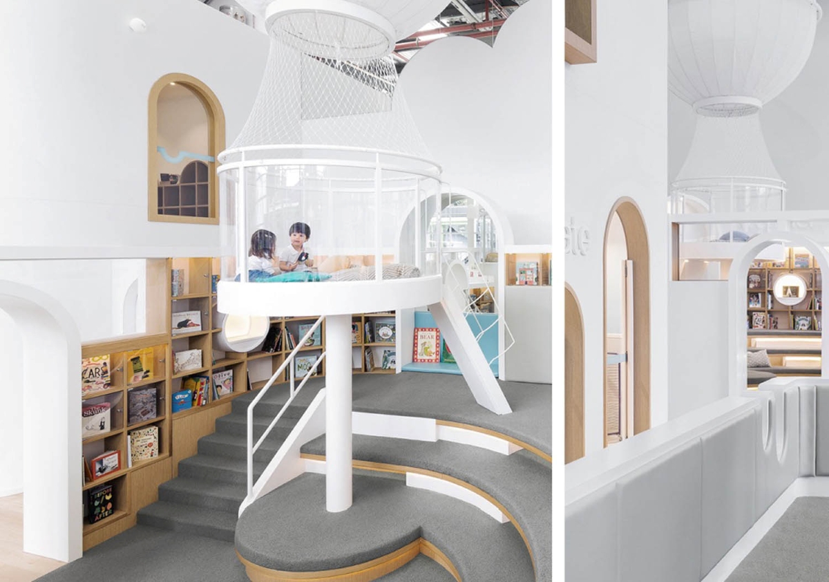 A luminous children’s library with arched windows, lofted play area, and cosy nooks.