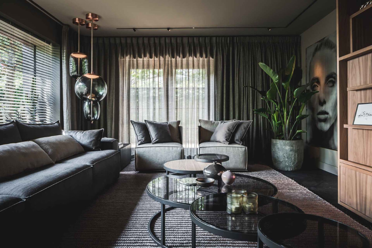 Luxurious living room with grey sofas, round glass tables, Brokis Knot pendants, and elegant décor.