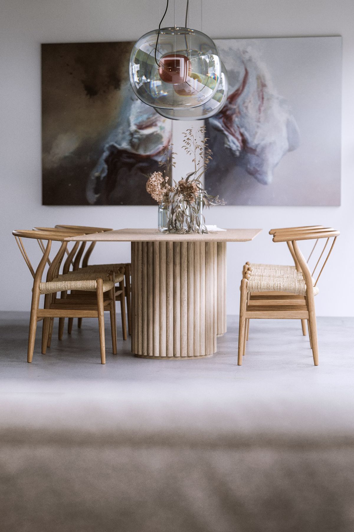 A dining room with a round wooden table, woven chairs, a large abstract painting, and Brokis Big One Large pendants above.