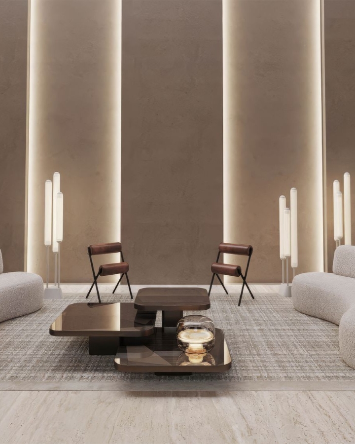 Minimalist lounge with taupe walls, white Brokis lighting accents, curved sofas, and rich brown chairs around sleek tables.