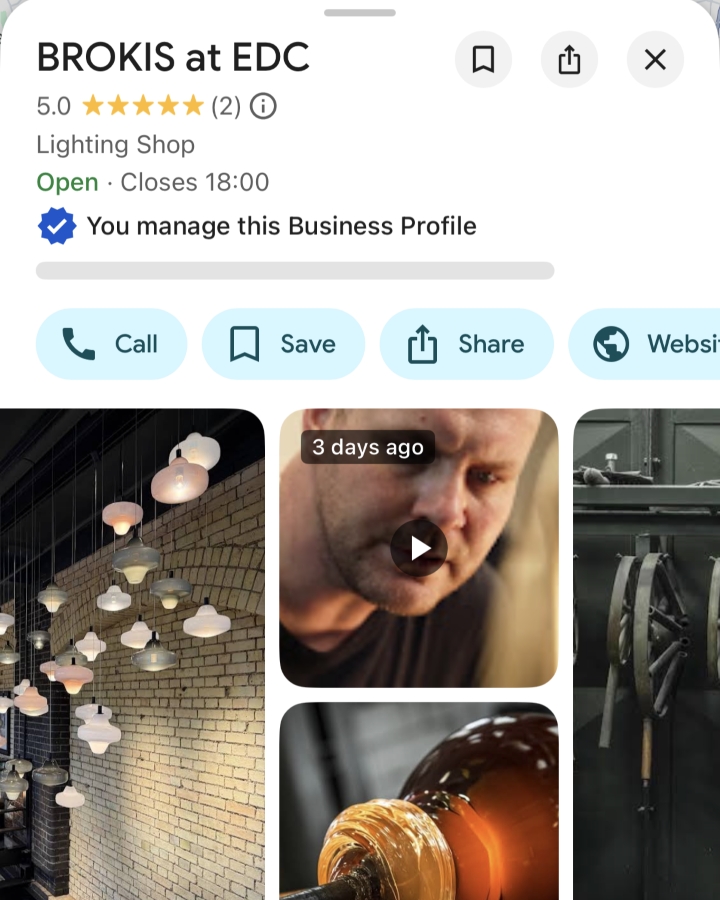 Screenshot of a business profile for BROKIS at EDC, a lighting shop rated 5 stars. Images show modern pendant lights, a person working with glass, and glassblowing equipment. Business info and buttons are visible at the top.